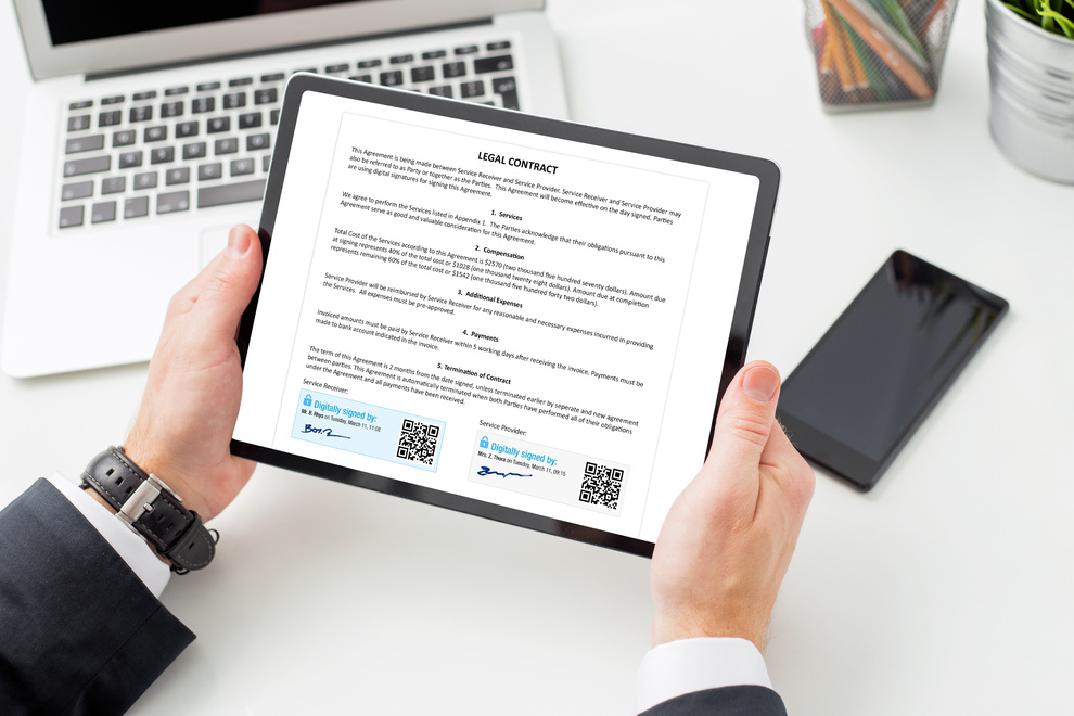 Man at work signing legal contract by using digital signature